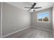 Bright bedroom with a ceiling fan, light gray walls, and light plank flooring at 3245 N 43Rd N Ave, Phoenix, AZ 85031
