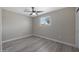 Bedroom featuring light plank flooring, a ceiling fan, and large window at 3245 N 43Rd N Ave, Phoenix, AZ 85031