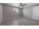 Bright bedroom with a ceiling fan, light gray walls, and light plank flooring at 3245 N 43Rd N Ave, Phoenix, AZ 85031