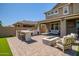 Nice outdoor kitchen, BBQ, and seating in a well-maintained backyard at 33275 N 132Nd Ave, Peoria, AZ 85383