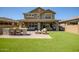 Wide angle of a backyard with an outdoor grill, dining area, and comfortable lounge seating at 33275 N 132Nd Ave, Peoria, AZ 85383