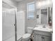 The bathroom features a glass-enclosed shower, a white toilet, and a single sink vanity with gray cabinetry at 33275 N 132Nd Ave, Peoria, AZ 85383