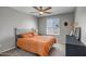 Well-lit bedroom with a comfortable bed, neutral color palette, ample natural light, and a sleek black dresser at 33275 N 132Nd Ave, Peoria, AZ 85383