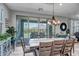 Elegant dining area with a spacious table, designer lighting, and a view to the backyard at 33275 N 132Nd Ave, Peoria, AZ 85383