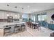 Open kitchen layout with granite island, stainless appliances, white cabinets, and a seamless flow to the dining area at 33275 N 132Nd Ave, Peoria, AZ 85383