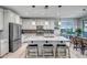 Bright, open kitchen featuring stainless appliances, a center island with barstool seating, and stylish pendant lighting at 33275 N 132Nd Ave, Peoria, AZ 85383