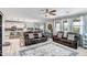Spacious open floor plan with a great room leading to the kitchen and dining area, featuring leather couches at 33275 N 132Nd Ave, Peoria, AZ 85383