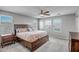 Cozy primary bedroom with a king-size bed, neutral decor, and plenty of natural light from the windows at 33275 N 132Nd Ave, Peoria, AZ 85383