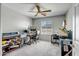 Home office with a ceiling fan, functional desks, and a comfortable chair in a room filled with natural light at 33275 N 132Nd Ave, Peoria, AZ 85383