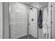 Modern shower with white subway tile, a glass door, and a dark shower floor at 33275 N 132Nd Ave, Peoria, AZ 85383