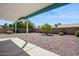 Backyard featuring a covered patio and low-maintenance landscaping with rocks and shrubs at 3417 W Abraham Ln, Phoenix, AZ 85027