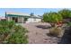 Backyard showcasing low-maintenance landscaping, rock ground cover, and a covered patio at 3417 W Abraham Ln, Phoenix, AZ 85027