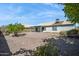 Backyard featuring low-maintenance landscaping, shrubs, rock ground cover, and a covered patio at 3417 W Abraham Ln, Phoenix, AZ 85027