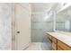Bathroom featuring sliding glass shower doors, white countertop, and decorative wallpaper at 3417 W Abraham Ln, Phoenix, AZ 85027
