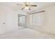 Bedroom featuring a ceiling fan, mirrored closet, and vertical blinds on the window at 3417 W Abraham Ln, Phoenix, AZ 85027