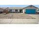 Charming single-story home with a low-maintenance gravel yard and a bright turquoise garage door at 3417 W Abraham Ln, Phoenix, AZ 85027