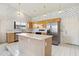 Functional kitchen features stainless steel appliances, an island, and a window overlooking the backyard at 3417 W Abraham Ln, Phoenix, AZ 85027