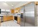 Cozy kitchen featuring wooden cabinets, floral wallpaper, and modern stainless steel refrigerator at 3417 W Abraham Ln, Phoenix, AZ 85027