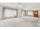 Spacious living room featuring large windows with elegant drapes and plush carpeting at 3417 W Abraham Ln, Phoenix, AZ 85027