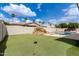 Manicured backyard with an artificial putting green, a rock feature, and a pool at 3528 E Decatur St, Mesa, AZ 85213