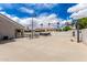 Backyard concrete area with basketball hoop, seating and trailer at 3528 E Decatur St, Mesa, AZ 85213