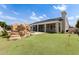 Backyard featuring mini golf course, rock waterfall, and covered patio with iron fencing at 3528 E Decatur St, Mesa, AZ 85213