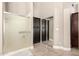 Bathroom featuring a glass-enclosed shower and built-in storage cabinets at 3528 E Decatur St, Mesa, AZ 85213