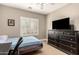 Bedroom with large window, dresser and a blue bed at 3528 E Decatur St, Mesa, AZ 85213