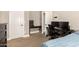 A furnished room with a desk setup and blue comforter at 3528 E Decatur St, Mesa, AZ 85213