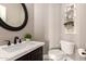 Stylish half bath featuring modern fixtures, an oval mirror, and decorative shelving at 3528 E Decatur St, Mesa, AZ 85213