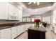Charming kitchen featuring white cabinets, granite countertops, and a beautiful island with floral decor at 3528 E Decatur St, Mesa, AZ 85213