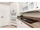 Well-equipped kitchen showcasing white cabinets, granite countertops, built-in appliances, and ample storage at 3528 E Decatur St, Mesa, AZ 85213