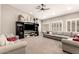 Spacious living room with comfortable seating, ceiling fan, and a large entertainment center at 3528 E Decatur St, Mesa, AZ 85213