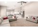Bright and airy living room featuring neutral tones, plush sofas, and an open layout to the kitchen at 3528 E Decatur St, Mesa, AZ 85213