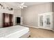 Bright main bedroom with vaulted ceiling, neutral finishes, a decorative cabinet, and French doors at 3528 E Decatur St, Mesa, AZ 85213