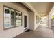Covered patio with windows, a door, and a black mat at 3528 E Decatur St, Mesa, AZ 85213