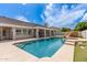 Backyard pool and spa with rock feature and beige decking at 3528 E Decatur St, Mesa, AZ 85213