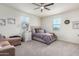 Cozy bedroom with neutral colors, ceiling fan, and large windows filling the room with natural light at 3855 S Mcqueen Rd # 24, Chandler, AZ 85286