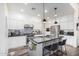 Modern kitchen featuring white cabinets, granite countertops, stainless steel appliances, and a center island with bar seating at 3855 S Mcqueen Rd # 24, Chandler, AZ 85286