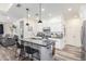 Modern kitchen features white cabinets, a granite island with seating, and stainless steel appliances at 3855 S Mcqueen Rd # 24, Chandler, AZ 85286