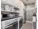 Well-organized laundry room with brick design, stainless steel appliances, and ample storage space at 3855 S Mcqueen Rd # 24, Chandler, AZ 85286