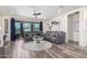 Inviting living room boasts a sectional sofa, sleek ceiling fan, and a decorative accent wall at 3855 S Mcqueen Rd # 24, Chandler, AZ 85286