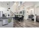Open-concept layout with a kitchen island, dining area, and staircase in a naturally lit space at 3855 S Mcqueen Rd # 24, Chandler, AZ 85286