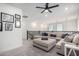 Relaxing loft area with a large comfortable couch, ottoman, ceiling fan, and staircase at 3855 S Mcqueen Rd # 24, Chandler, AZ 85286