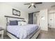 Comfortable main bedroom with a stylish bed, soft bedding, and an en-suite bathroom through a sliding barn door at 3855 S Mcqueen Rd # 24, Chandler, AZ 85286
