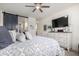 Comfortable main bedroom featuring a ceiling fan, TV, barn door, and stylish decor at 3855 S Mcqueen Rd # 24, Chandler, AZ 85286