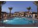 Sparkling community pool surrounded by palm trees and comfortable lounge chairs, perfect for recreation at 3855 S Mcqueen Rd # 24, Chandler, AZ 85286