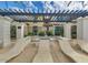 Community fire pit area, with lounge chairs, pergola, and desert landscaping at 3855 S Mcqueen Rd # 24, Chandler, AZ 85286