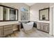 Elegant bathroom with a soaking tub, dual vanities, and mirrors for a luxurious feel at 4055 N Recker Rd # 82, Mesa, AZ 85215