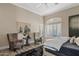 Relaxing bedroom showcasing comfortable seating, a decorative window, and ample natural light at 4055 N Recker Rd # 82, Mesa, AZ 85215